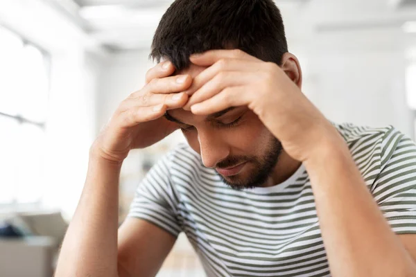 Primer plano del hombre estresado que tiene dolor de cabeza en casa — Foto de Stock
