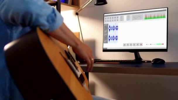 Muž hraje na kytaru a doma nahrává hudbu — Stock video