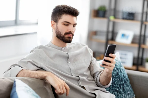 Joven con smartphone en casa — Foto de Stock