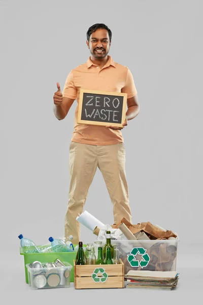 Smiling man sorting paper, glass and plastic waste — Stock Photo, Image