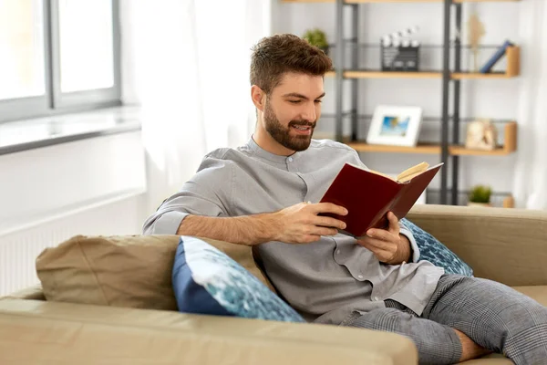 Hombre leyendo libro en casa — Foto de Stock