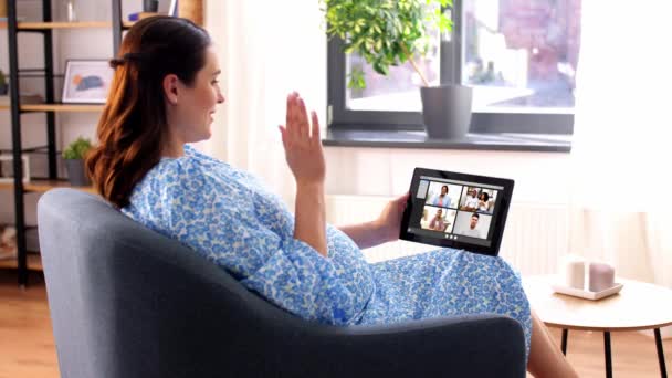 Pregnant woman with tablet pc having video call — Stock Video