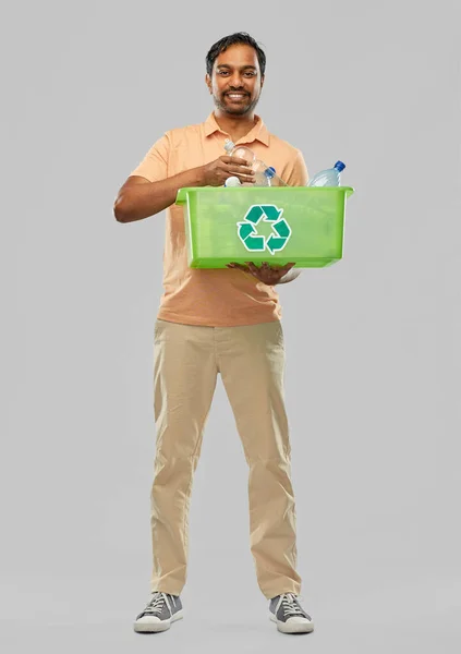 Smiling young indian man sorting plastic waste — Stock Photo, Image