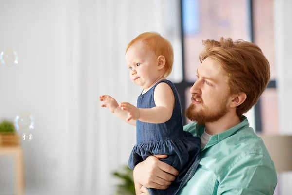 Padre E Hija Bebe Con Burbujas De Jabon En Casa Jugando Cabello Rojo Stock Photo Padre E Hija Bebe Con Burbujas De Jabon En Casa Jugando Cabello Rojo Stock Photo