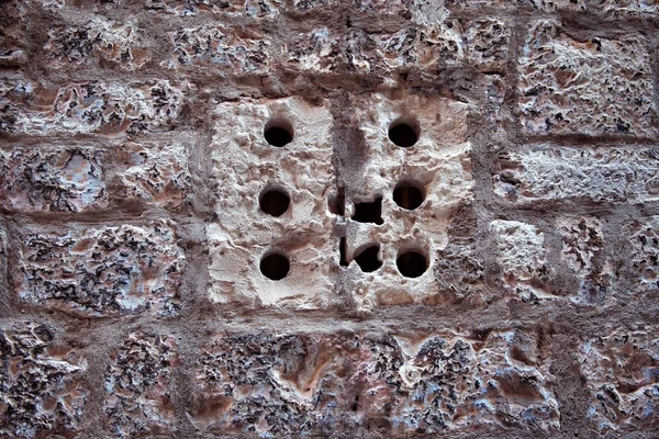 Stone Wall and window with holes in old town — Stock Photo, Image