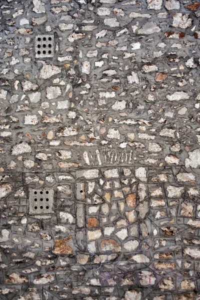 Wall with a former window laid with stones in old town — Stock Photo, Image