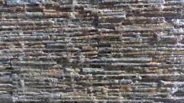 Stone wall rough surface with water stream flowing over — Stock Video