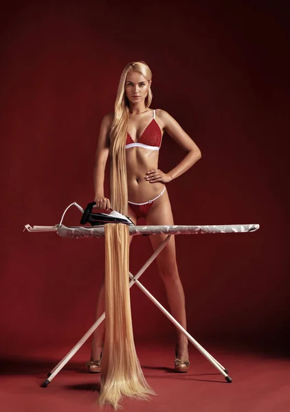 Conceptual Picture Blond Woman Ironing Her Hair — Stock Photo, Image