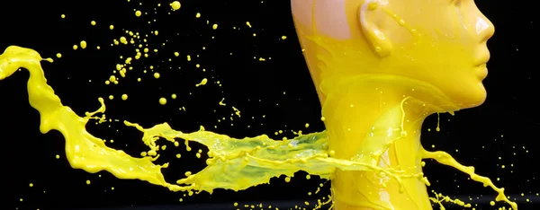 Mannequin splashed with yellow paint