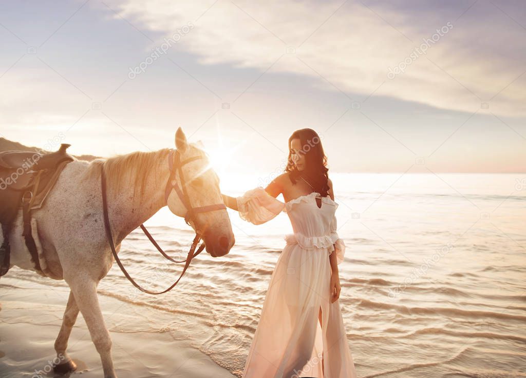 Beautiful, young woman with a calm horse