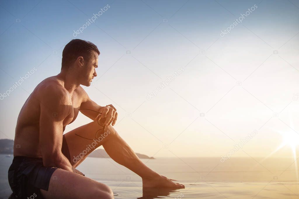 Portrait of a serious man in a tropical pool