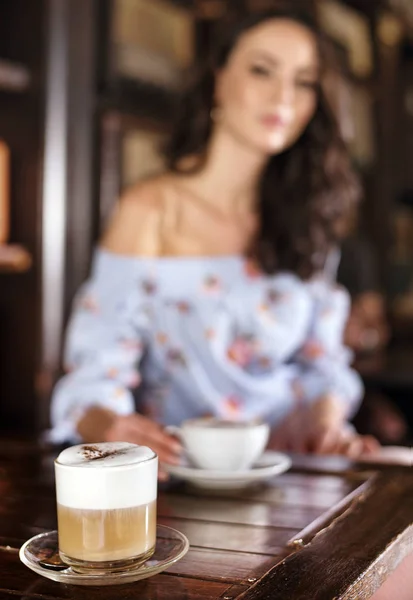 Verschwommenes Porträt einer brünetten Frau in einem Café — Stockfoto