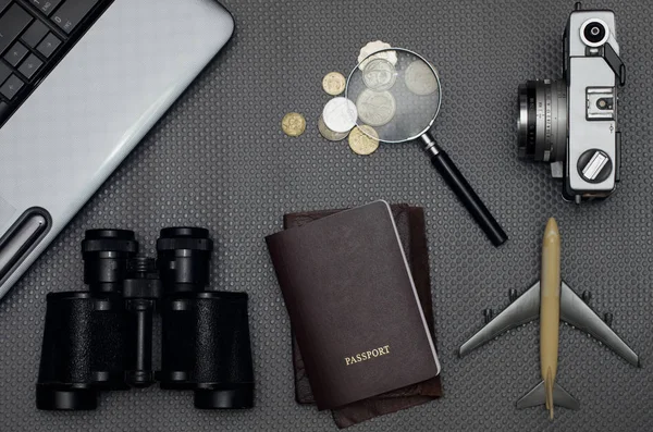 Flat lay of travel gadgets on work desk with passport and coins, Vacation concept