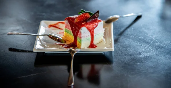 Nice fancy cake, Crepe cake with strawberry sauce on table