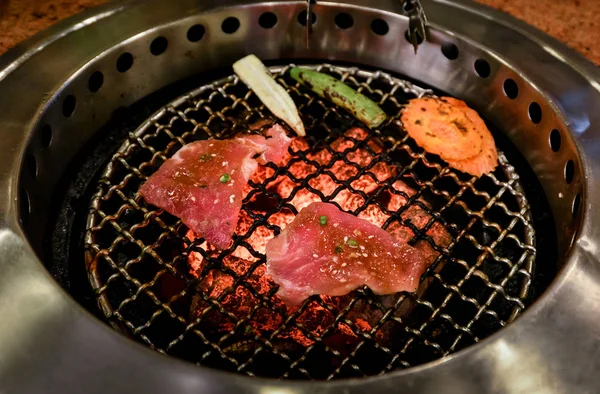 Grilled meat on hot stove — Stock Photo, Image