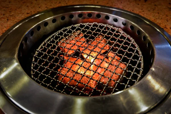 Fire in stove ready for BBQ at table — Stock Photo, Image