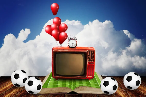 Vintage television on open book of football field with footballs