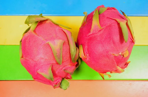 Dragon fruit on colorful table — Stock Photo, Image