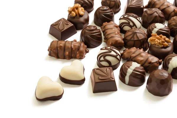 Assortment of chocolate candies from black, milk and white chocolate with nuts and marzipan — Stock Photo, Image