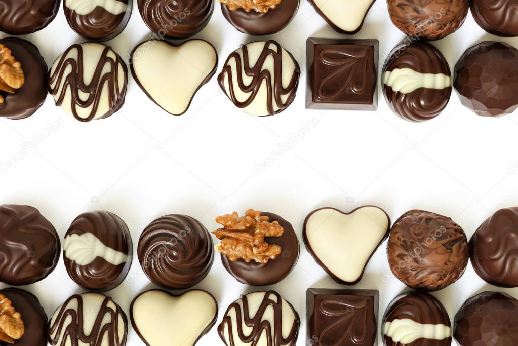 Assortment of chocolate candies from black, milk and white chocolate with nuts and marzipan