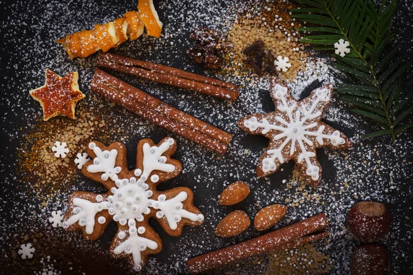 Fondo de Navidad o Año Nuevo de galletas de jengibre, especias, nueces con azúcar y copos de nieve. Vista superior . — Foto de Stock