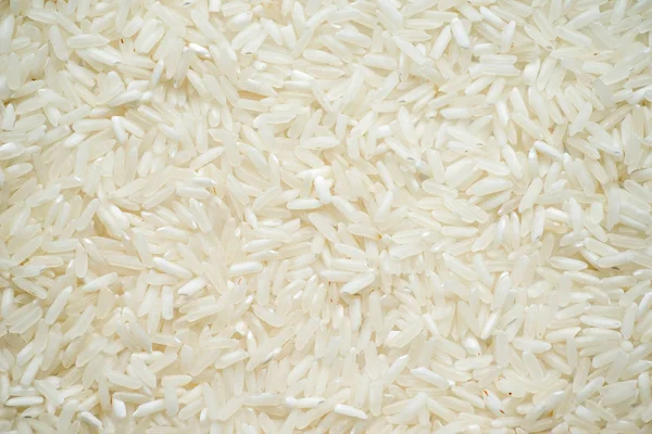 Fehér hosszú rizs háttér, nyers nyers gabonafélékre — Stock Fotó