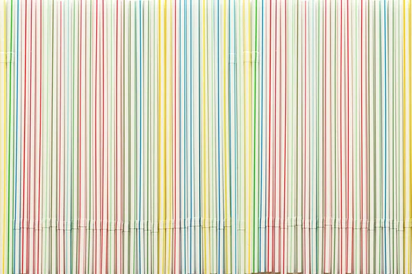 Striped plastic cocktail straws as background — Stock Photo, Image