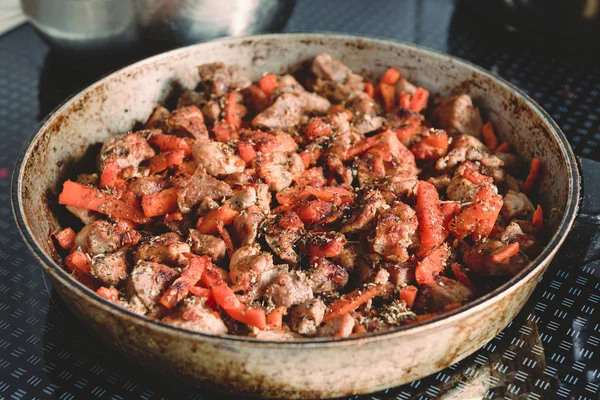 Sliced meat with carrots and spices fried in a pan — Stock Photo, Image