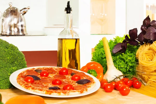 Pizza and other Italian cuisine food olive oil, vegetables on the table