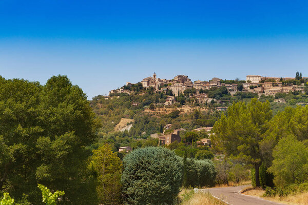 Gordes town view from the road, commune in the Vaucluse department in the Provence-Alpes-Cote d'Azur region in southeastern France