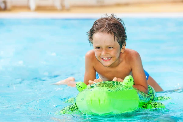 Portrait Happy Boy Riding Big Green Inflatable Toy Swimming Pool — Stock Photo, Image