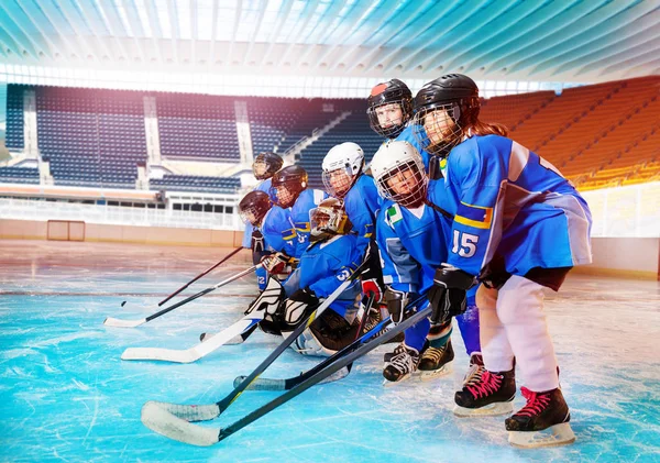 Portrait of big group of children, ice hockey players, getting ready for tournament at stadium