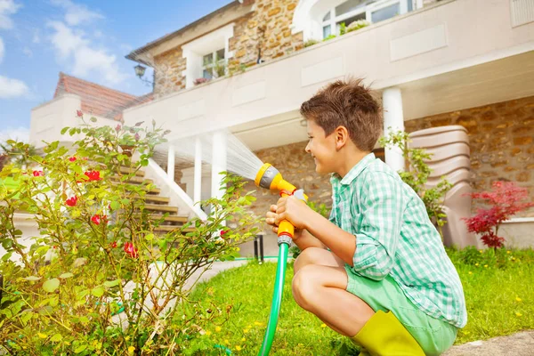 Side View Portrait Seven Years Old Boy Watering Rosebushes Using — Stock Photo, Image