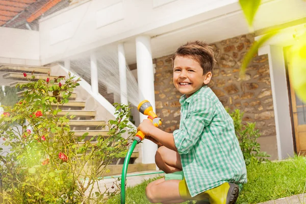 Portrait Little Boy Watering Rosebushes Using Hand Sprinkler Smiling Looking — Stock Photo, Image