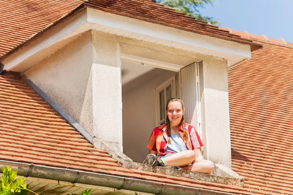 Low Angle Portrait Happy Teenage Girl Sitting Ledge Attic Window — Stock Photo, Image