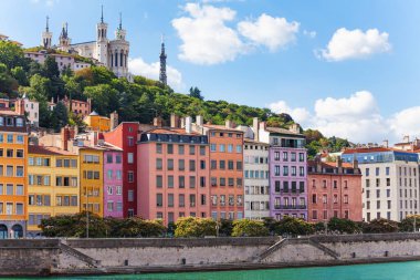 Scenic view of St. Georges district of old Lyon with its color houses and Basilica of Notre-Dame de Fourviere on the background clipart