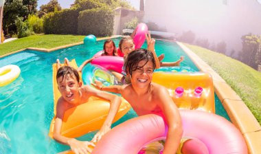 Portrait of teenage boys and girls, happy friends, having fun at open air swimming pool party clipart