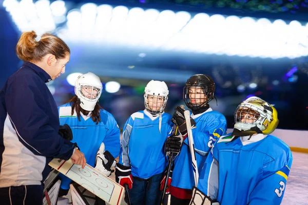 Female Coach Discussing Game Plan Young Hockey Players Ice Rink — Stock Photo, Image