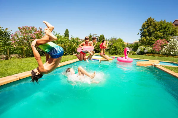 Grupo Adolescentes Felices Divirtiéndose Piscina Aire Libre Saltando Salpicando Agua — Foto de Stock