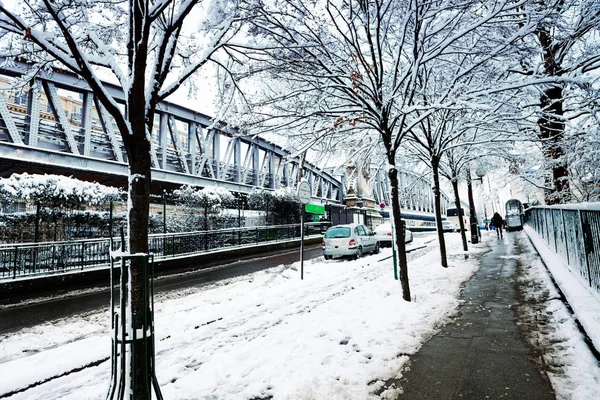 Boulevard de la Villette and metro line near square of Stalingrad battle with record snow amount for Paris