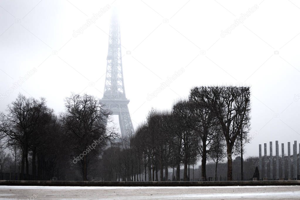 The Eifel Tower viewed from Champs de Mars in foggy winter day, Paris, France