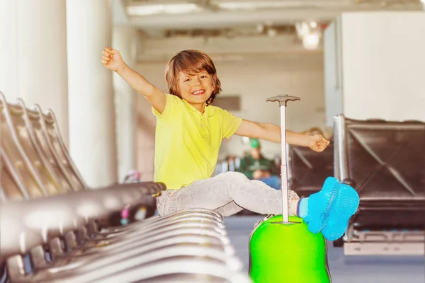Cheerful Boy Sitting Seat Putting His Legs Suitcase Departure Terminal — Stock Photo, Image