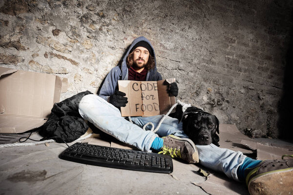 Jobless man sitting on city sidewalk with his dog