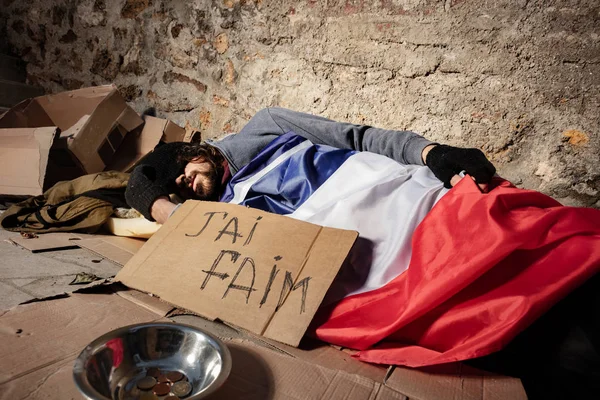 Sans-abri dormant dehors sous pavillon français — Photo