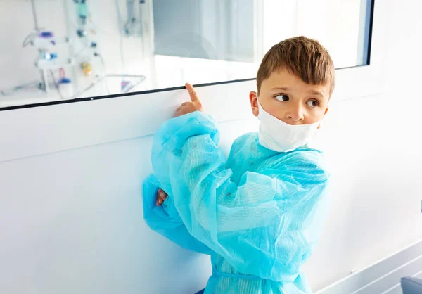 Little Boy Hospital Robe Wearing Medical Mask Worried Pointing Finger — Stock Photo, Image