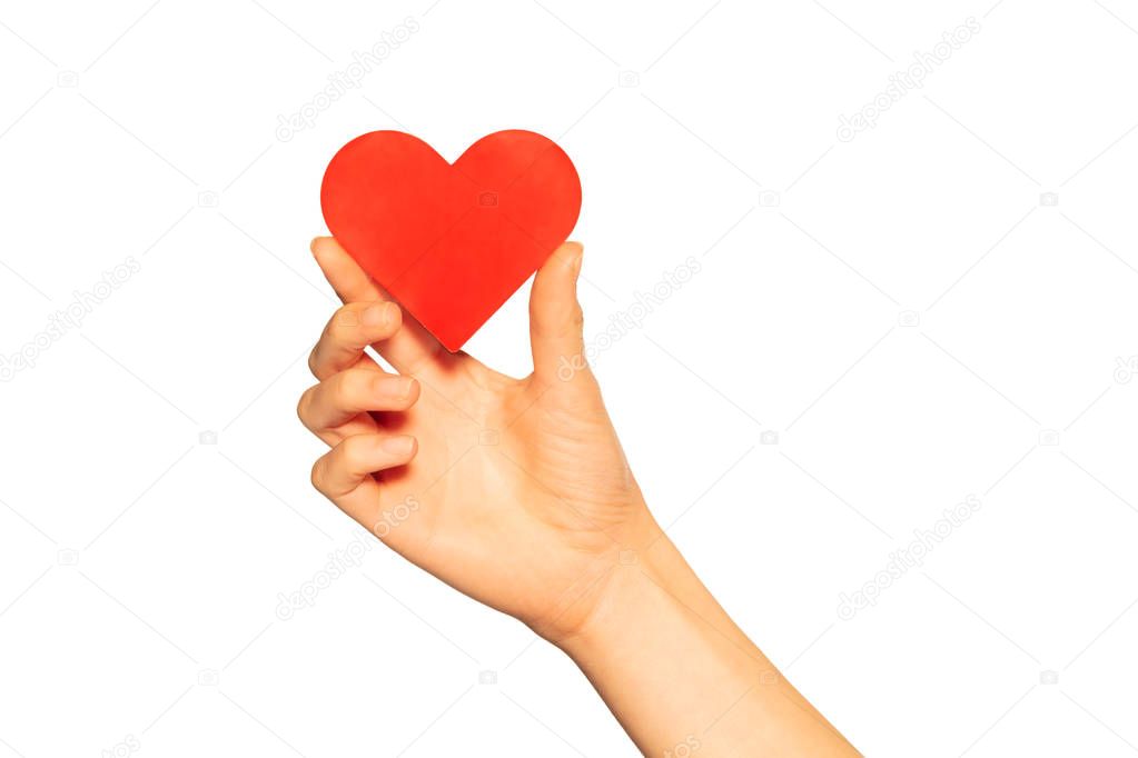 Close up of female hand holding red paper heart shaped card, isolated on white background