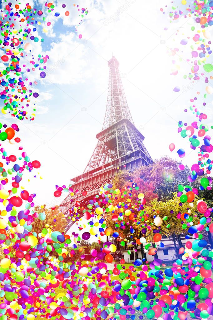 Eifel tower on Champs de Mars, Paris, France with many colorful air balloons flying around, festive celebration concept