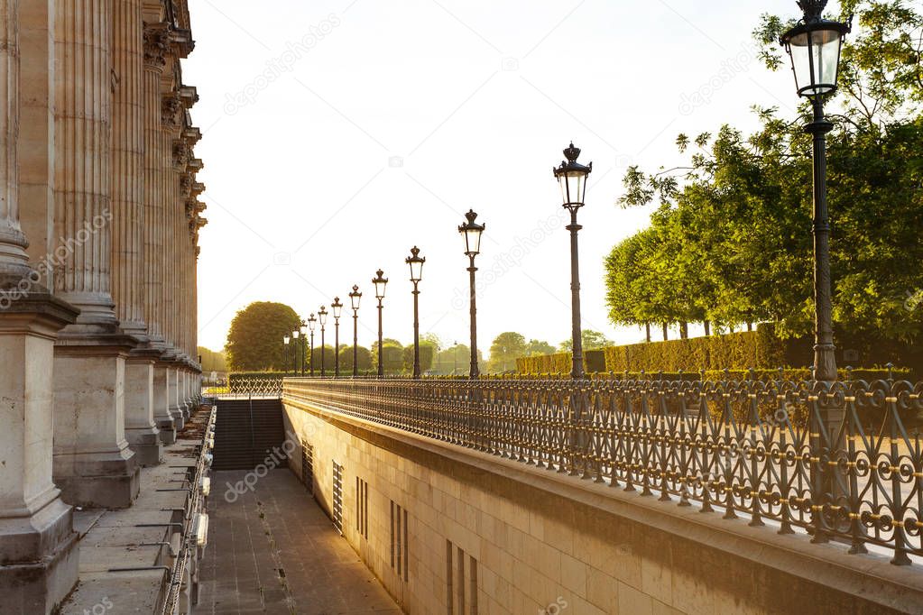 Fence in the park near Louvre Palace in the evening lights