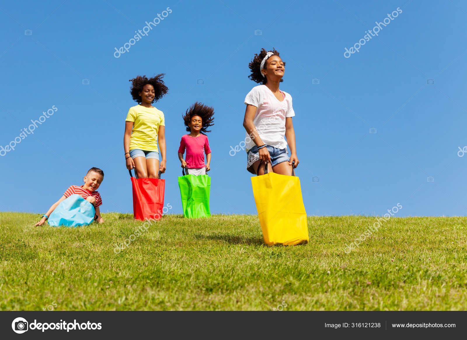 Group Kids Play Gunny Sack Race Competitive Game Field Hop Stock Photo by ©serrnovik 316121238