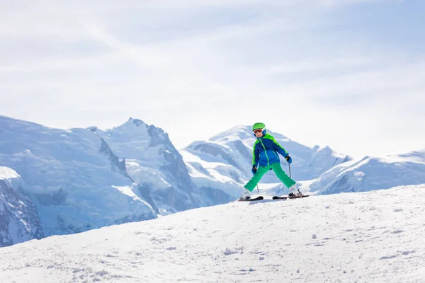 美しい山のシーンに対して斜面を下り 十代の少年 幸せなスキーヤーの肖像画 — ストック写真